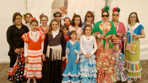 Un grupo de mujeres, ataviadas con traje de flamenca, posan durante la feria. 