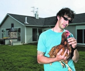 Eduardo Otxoa sujeta a una de las gallinas que alquila. Suele aconsejar instalarlas en un jardín, aunque también proporciona animales a clientes que únicamente disponen de una terraza. ::
LUIS AZANZA