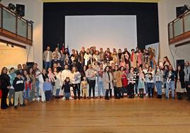 Los bebés nacidos en 2023 juntos a sus padres durante el acto.