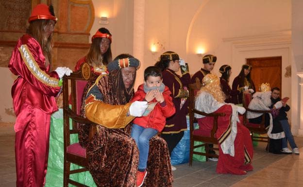 Los Reyes Magos recibiendo a los niños. 