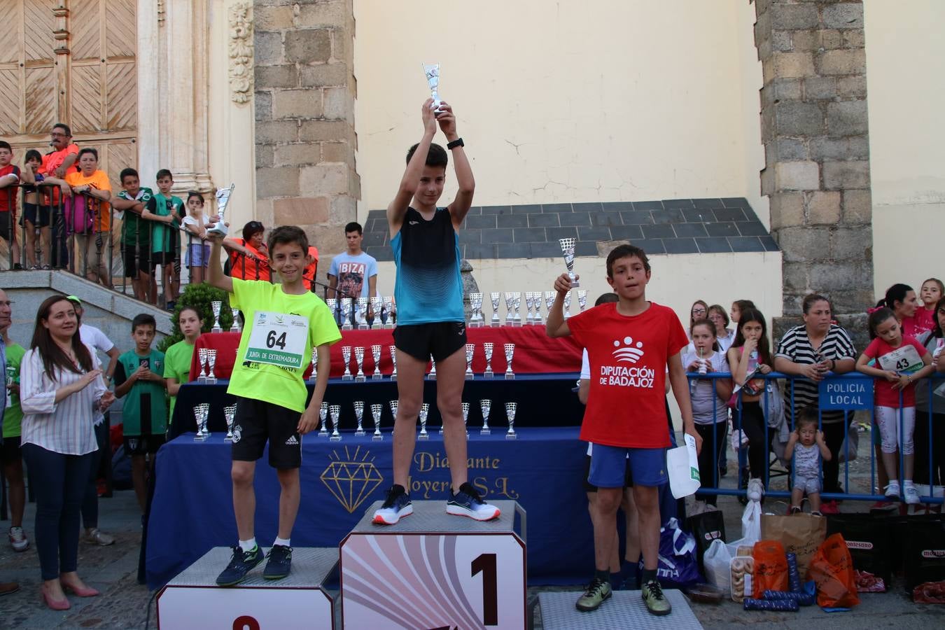 La Plaza de España de Jerez de los Caballeros acogió, ayer, la XXI Carrera Popular y VIII Caminata por la Salud y Solidaridad, organizada por la Concejalía de Juventud y Deportes del Ayuntamiento de Jerez con el apoyo del Programa de Dinamización Deportiva de la Mancomunidad Sierra Suroeste. Esta edición congregó a más de 250 participantes entre todas las categorías y se recaudaron 84 kilos de alimentos y 75 euros destinados a Cruz Roja en Jerez. La citada prueba se consagra, año tras año, como una de las citas deportivas ineludibles y más esperadas por los jerezanos y jerezanas. 
