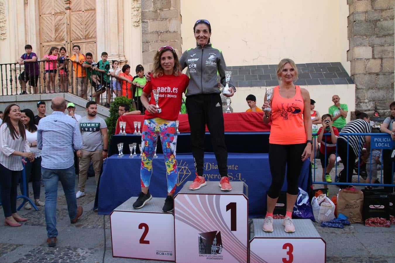 La Plaza de España de Jerez de los Caballeros acogió, ayer, la XXI Carrera Popular y VIII Caminata por la Salud y Solidaridad, organizada por la Concejalía de Juventud y Deportes del Ayuntamiento de Jerez con el apoyo del Programa de Dinamización Deportiva de la Mancomunidad Sierra Suroeste. Esta edición congregó a más de 250 participantes entre todas las categorías y se recaudaron 84 kilos de alimentos y 75 euros destinados a Cruz Roja en Jerez. La citada prueba se consagra, año tras año, como una de las citas deportivas ineludibles y más esperadas por los jerezanos y jerezanas. 