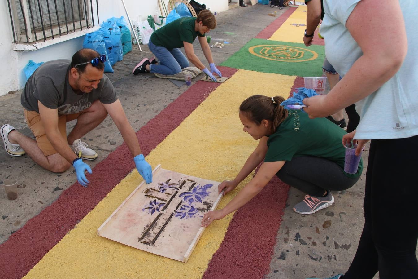 Las alfombras de sal embellecen y llenan de color, hoy, las calles de Jerez de los Caballeros con motivo de la festividad del Corpus Christi. Desde primera hora de la mañana, miembros de las cofradías y hermandades, Cáritas, grupos de catequesis, familias de los niños que han hecho este año la Primera Comunión, miembros de la Asociación de costaleros y costaleras de la Semana Santa jerezana, Ayuntamiento y vecinos han cubierto las principales calles del municipio con 6.250 kilos de sal teñida, plenas de color. A continuación, han disfrutado de una jornada de convivencia en la Casa de la Iglesia 'Cecilia de Arteaga'.