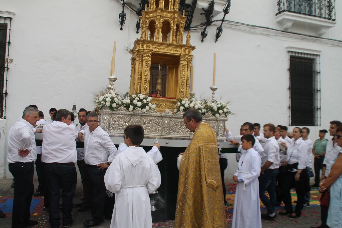 Jerez de los Caballeros celebró ayer la festividad del Corpus Christi en medio de un ambiente de solemnidad y convivencia del que fueron partícipes cientos de personas.La iglesia visigoda de Santa María de la Encarnación, llena de fieles, acogió la celebración de la Eucaristía que dió paso a la procesión acompañando la Santa Custodia en el magnífico templete de la iglesia de San Miguel, sobre las andas de la Virgen de Aguasantas y portada por costaleros y costaleras de la recién Asociación creada en esta ciudad. El párroco, Antonio María Rejano, destacó la significación de esta procesión, lamás grande, dijo, «porque Jesús sale a nuestras vidas, a nuestro encuentro y nosotros le acompañamos». Al término de la misa, incidió en el agradecimiento a todas las personas que han participado para hacer posible su desarrollo, trabajando desde la jornada del sábado en la elaboración de las preciosas alfombras de sal teñida de colores, que lucieron en las calles del centro de Jerez. El agradecimiento fue especial para los padres y madres de los niños y niñas que han hecho la Primera Comunión, para éstos mismos, también para catequistas, Cofradías y Hermandades, la Asociación del costaleros y costaleras de la Semana Santa de Jerez de los Caballeros, Ayuntamiento, Policía Local, grupos y personas de la parroquia.Autoridades civiles en representación del Ayuntamiento, Policía Local y Guardia Civil, acompañaron el desarrollo de la procesión junto a representantes de todas las cofradías y hermandades jerezanas y el protagonismo de los más de 80 niños y niñas que este año han celebrado su Primera Comunión.  A lo largo de todo el recorrido se instalaron distintos altares, también con la colaboración de vecinos y centros como la Residencia de Mayores Hernando de Soto. Los magníficos sones de la Agrupación Musical 'Nuestro Padre Jesús Nazareno' coronaron esta hermosa procesión.