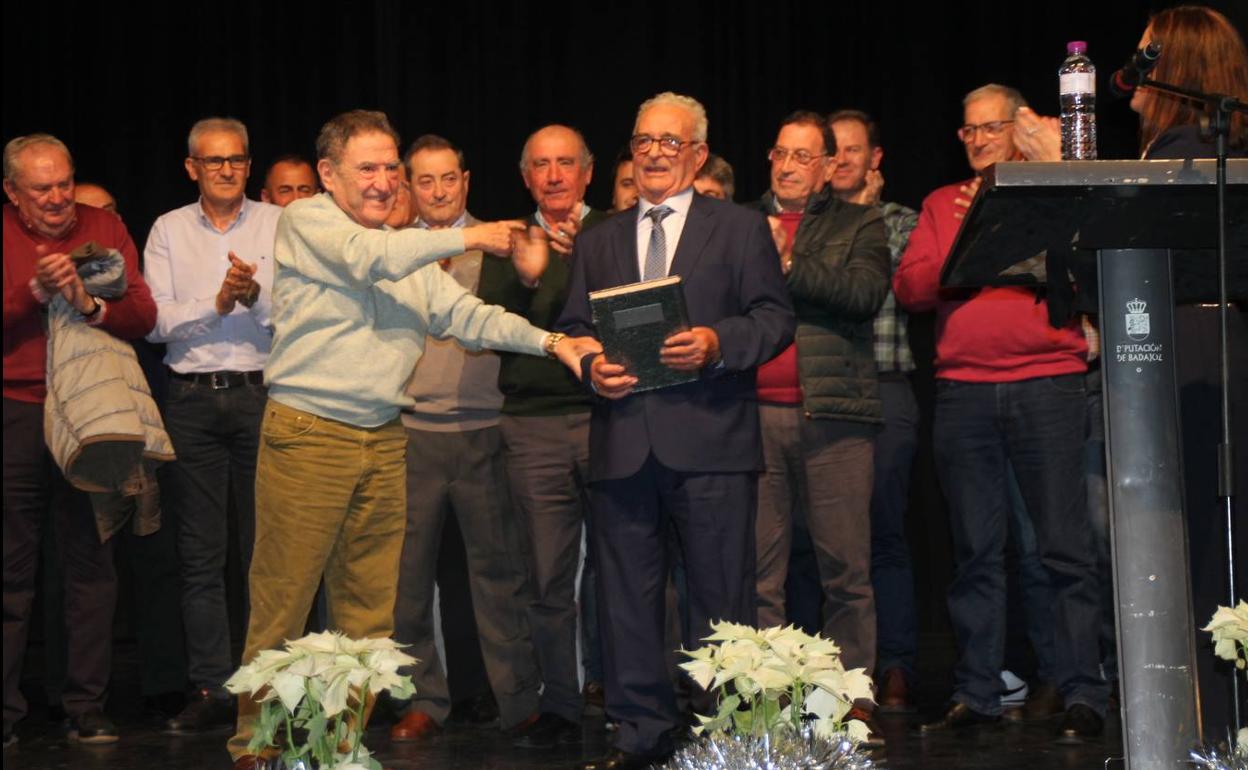 Alfonso Gallardo recibiendo de su primer empleado, Francisco Escobar, un libro de firmas de sus trabajadores.