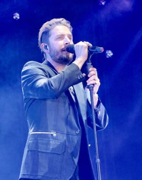 Imagen secundaria 2 - Arriba, montaje del gran escenario en los días previos del concierto. Abajo, a la izquierda, colas para entrar. A la derecha, el cantante Manuel Carrasco durante su concierto. 