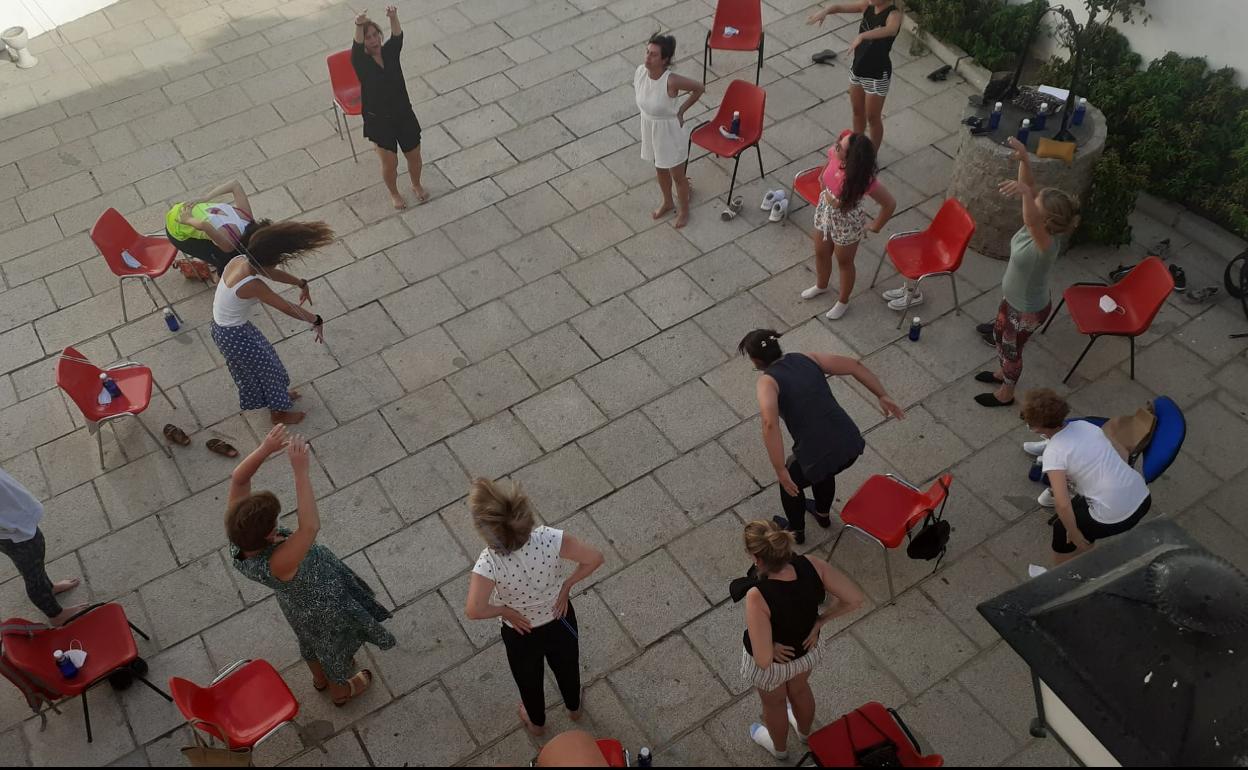 Las participantes hacen ejercicios en el patio del auditorio 