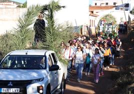 Comitiva realizando el 'Camino a San Isidro', con el Santo y las carrozas al fondo