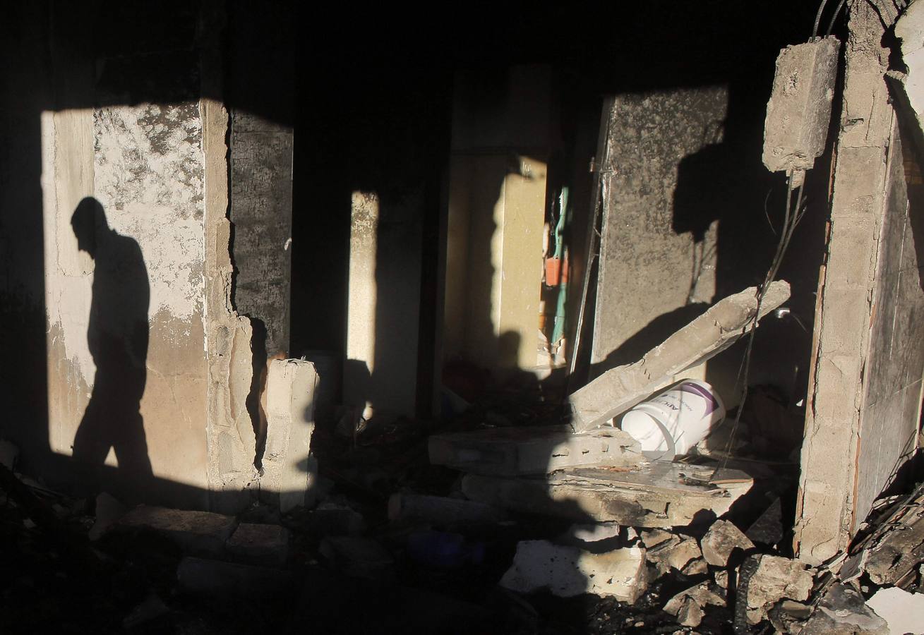 Martes, 1 de julio. Un palestino inspecciona la casa familiar de uno de los preseuntos secuestradores, después de que tropas israelíes detonaran un explosivo en la planta superior de la vivienda, situada en la ciudad cisjordana de Hebrón, REUTERS / Ammar Awad (CISJORDANIA - Tags: POLITICS DISTURBIOS CIVILES MILITARES)