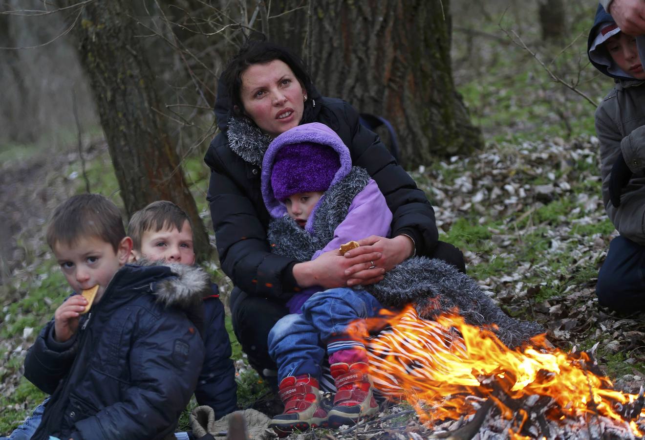 Una familia de kosovares se calienta alrededor de un fuego después de cruzar ilegalmente la frontera entre Serbia y Hungría, cerca del pueblo de Ásotthalom. Fotografía: REUTERS / Lazlo Balogh.