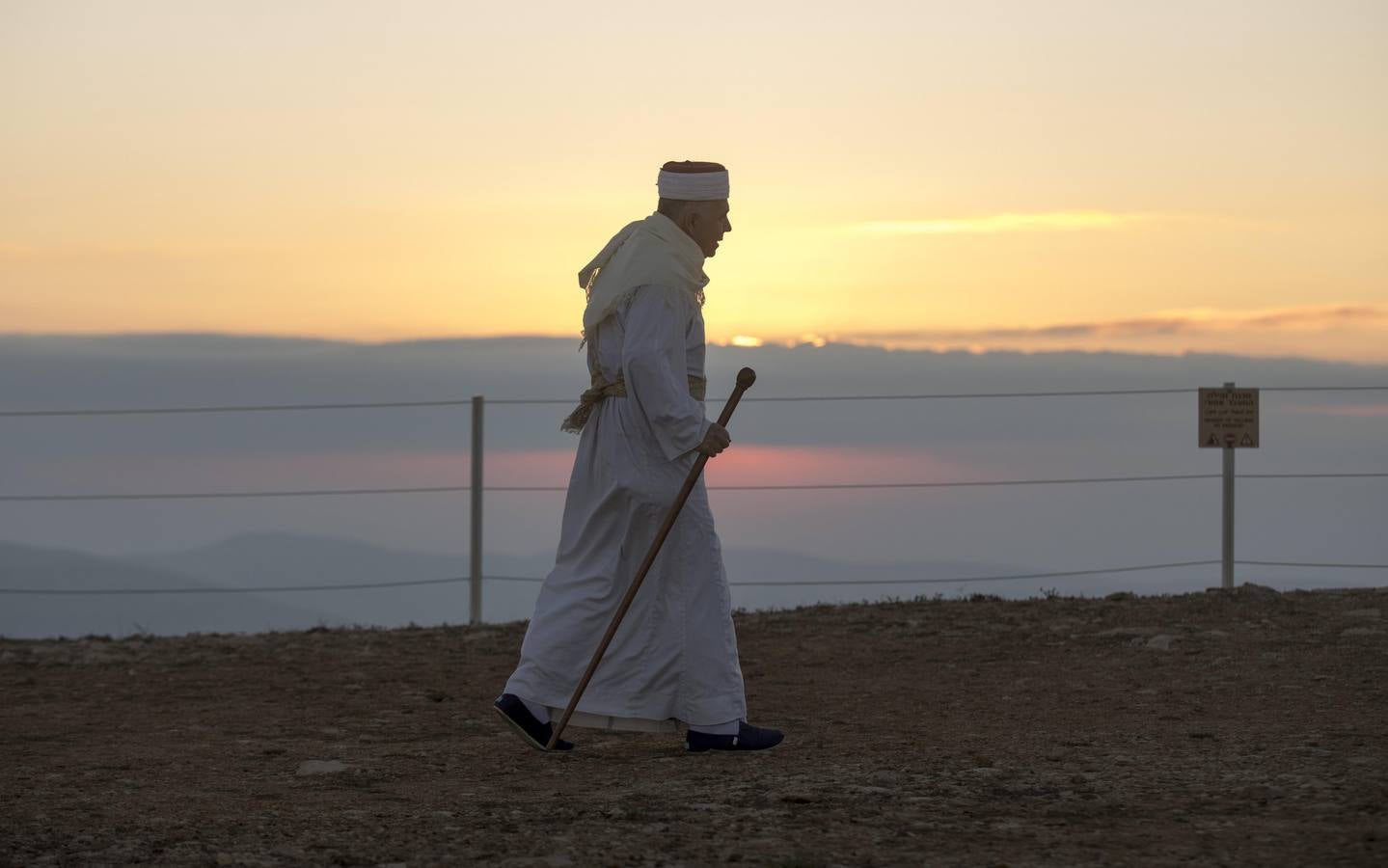 Miembros de la comunidad samaritana caminan hacia la cima del Monte Guerizín al amanecer en Nablus (Palestina), con motivo de la celebración del Sukot o fiesta de los tabernáculos.