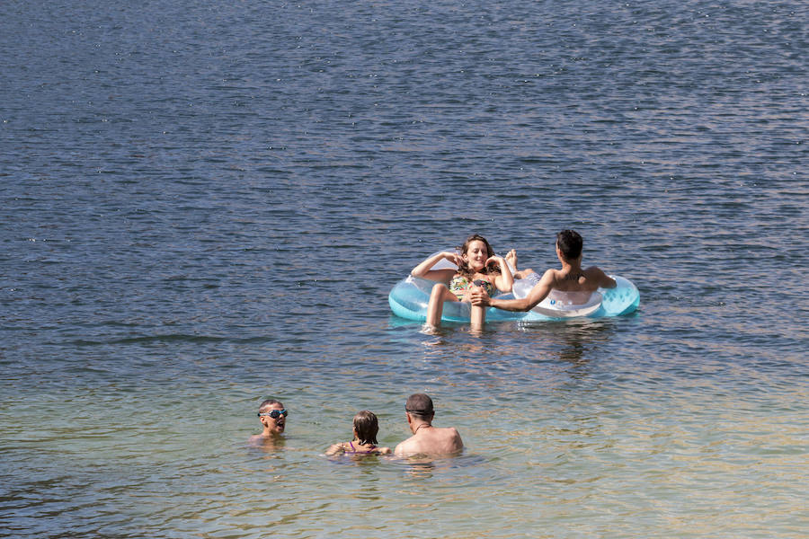 Bañistas en la piscina natural habilitada en la antigua cantera ubicada junto al embalse José María de Oriol, en Alcántara.