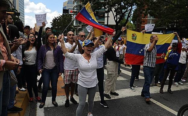 Opositores venezolanos participan en una manifestación para exigir el fin de la crisis y en respaldo a la Presidencia interina de Juan Guaidó, este miércoles, en Caracas (Venezuela).