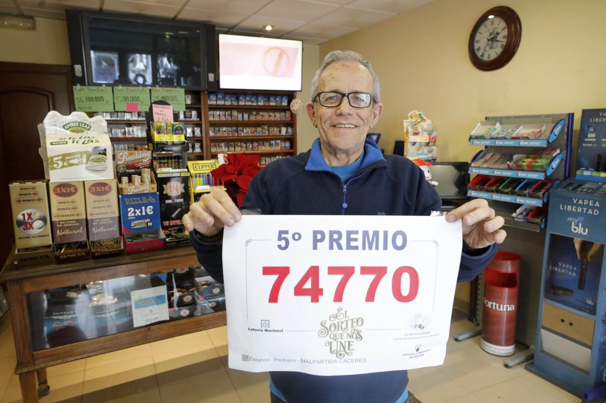 Emilio Pedrazo en su estanco con el número premiado. :: l. c.