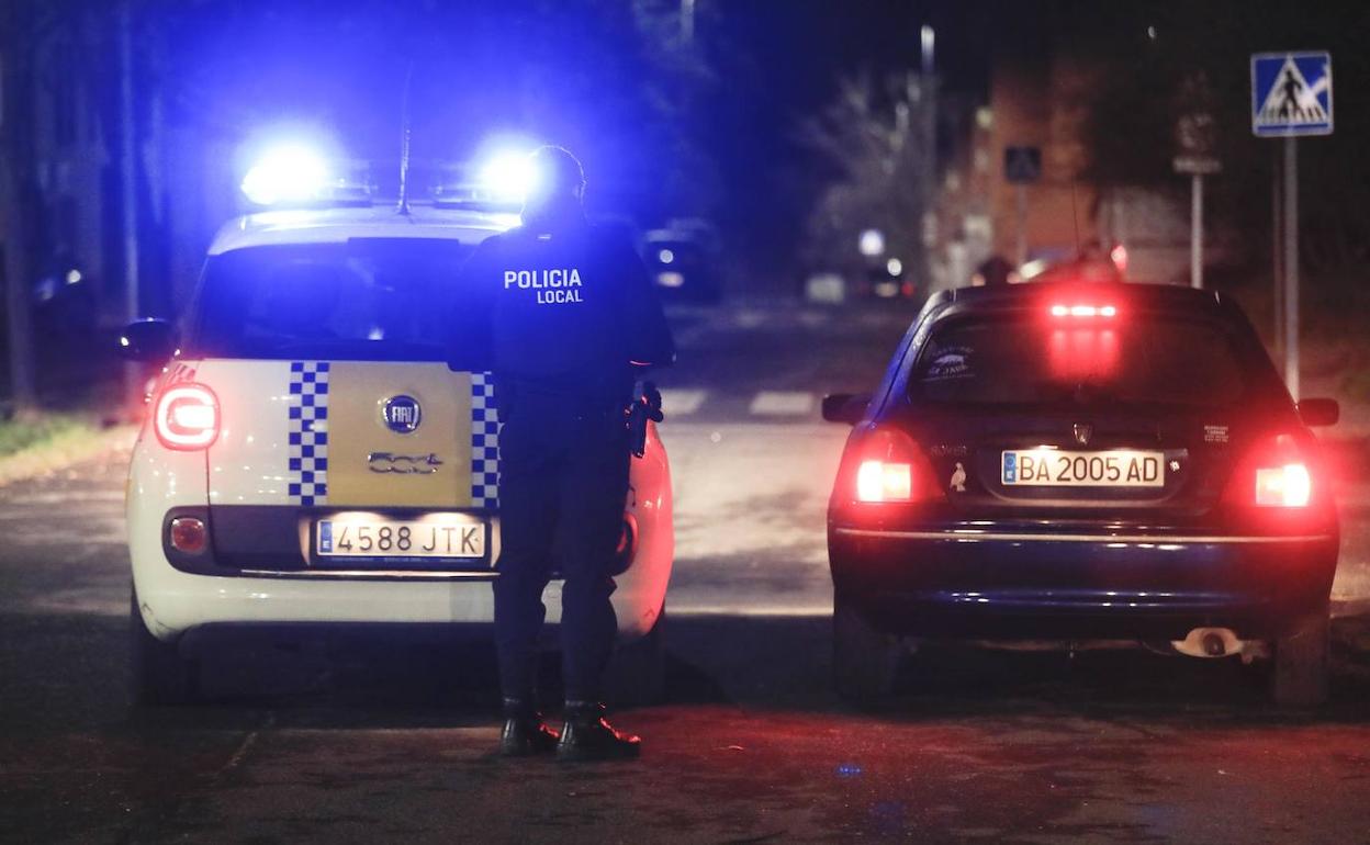 Un policía local patrulla por la noche en una calle de Cáceres.