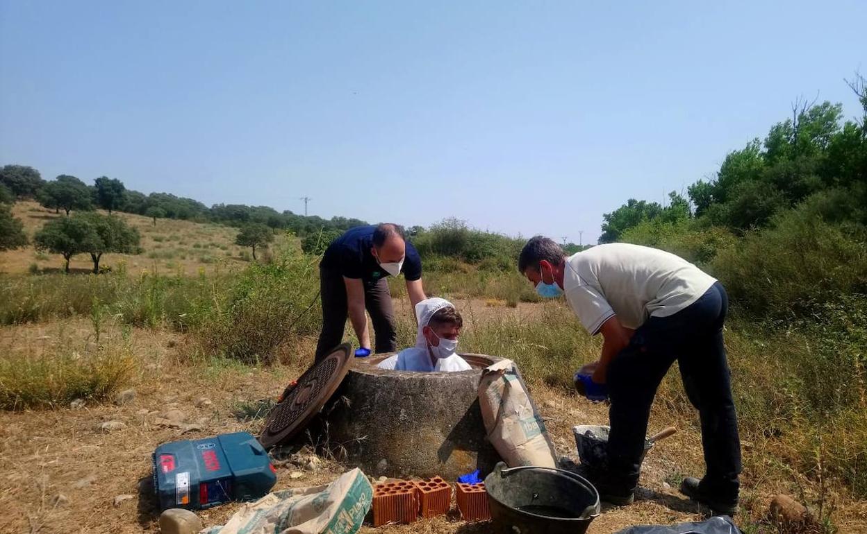 Un técnico recogiendo muestras de aguas residuales en una alcantarilla.