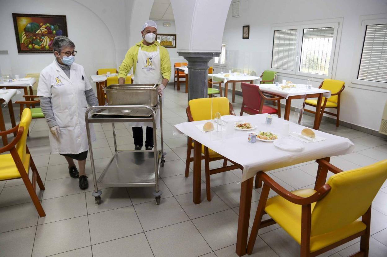 Dos voluntarios preparando el reparto de comidas de ayer. 