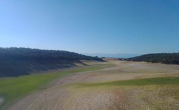 Parte del embalse de Valdecañas sin agua, seca por completo.