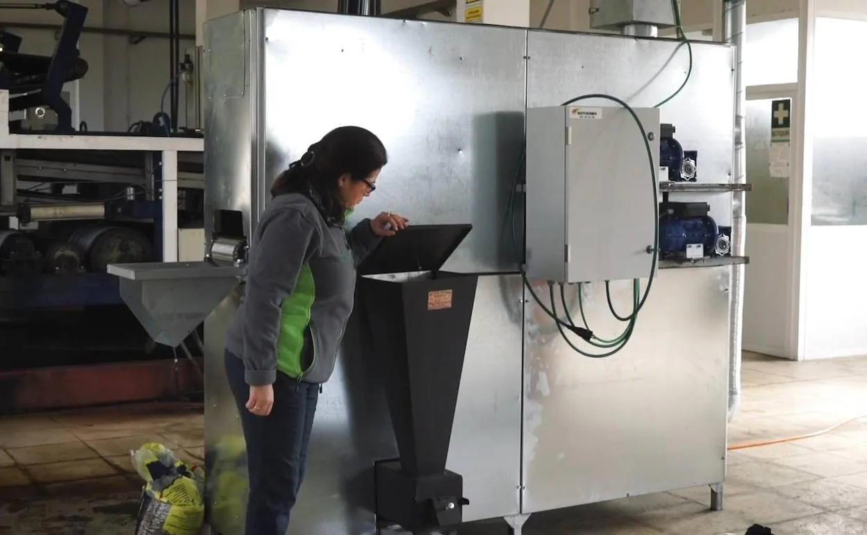Una trabajadora utilizando el prototipo de pellets de biomasa. 