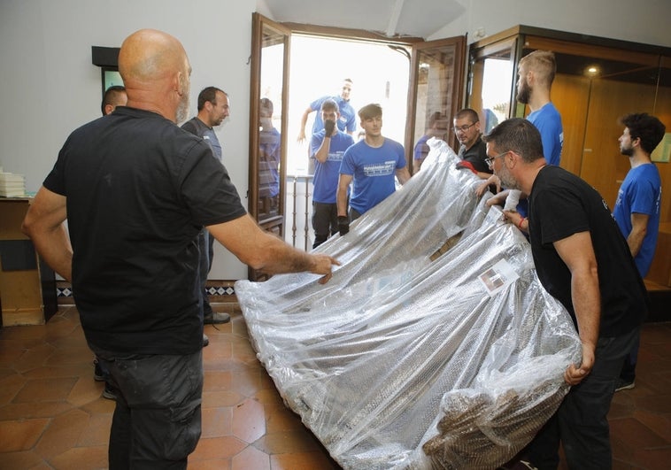 Traslado de una barca de pesca fluvial de la sección de Etnografía del Museo de Cáceres, en la primera planta de la casa de las Veletas.