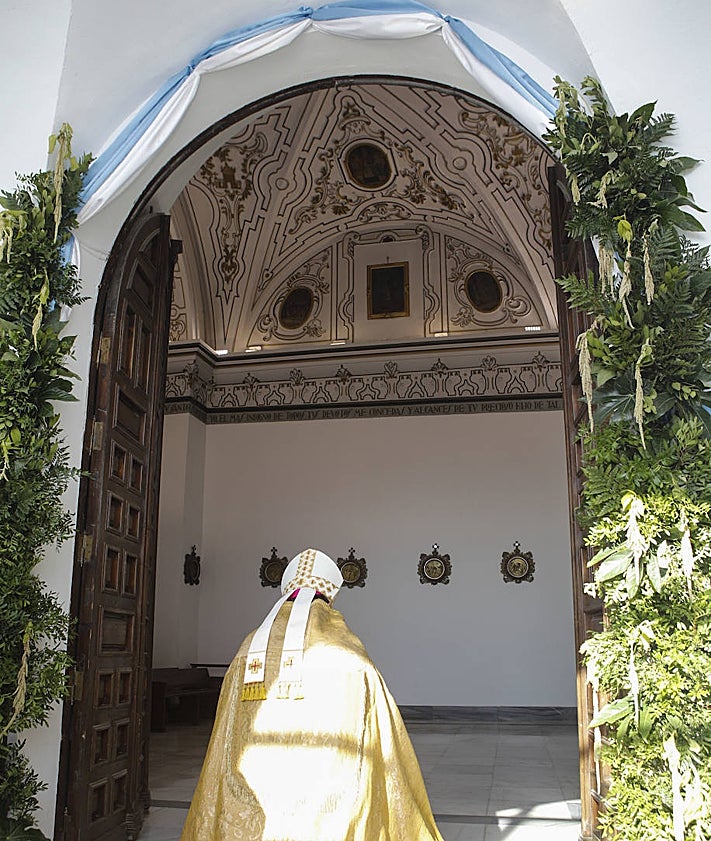 Imagen secundaria 2 - Unas 500 personas siguieron la ceremonia en la explanada a pleno sol. Debajo, colas para acudir a la puerta Santa y el obispo, Jesús Pulido, tras su apertura.
