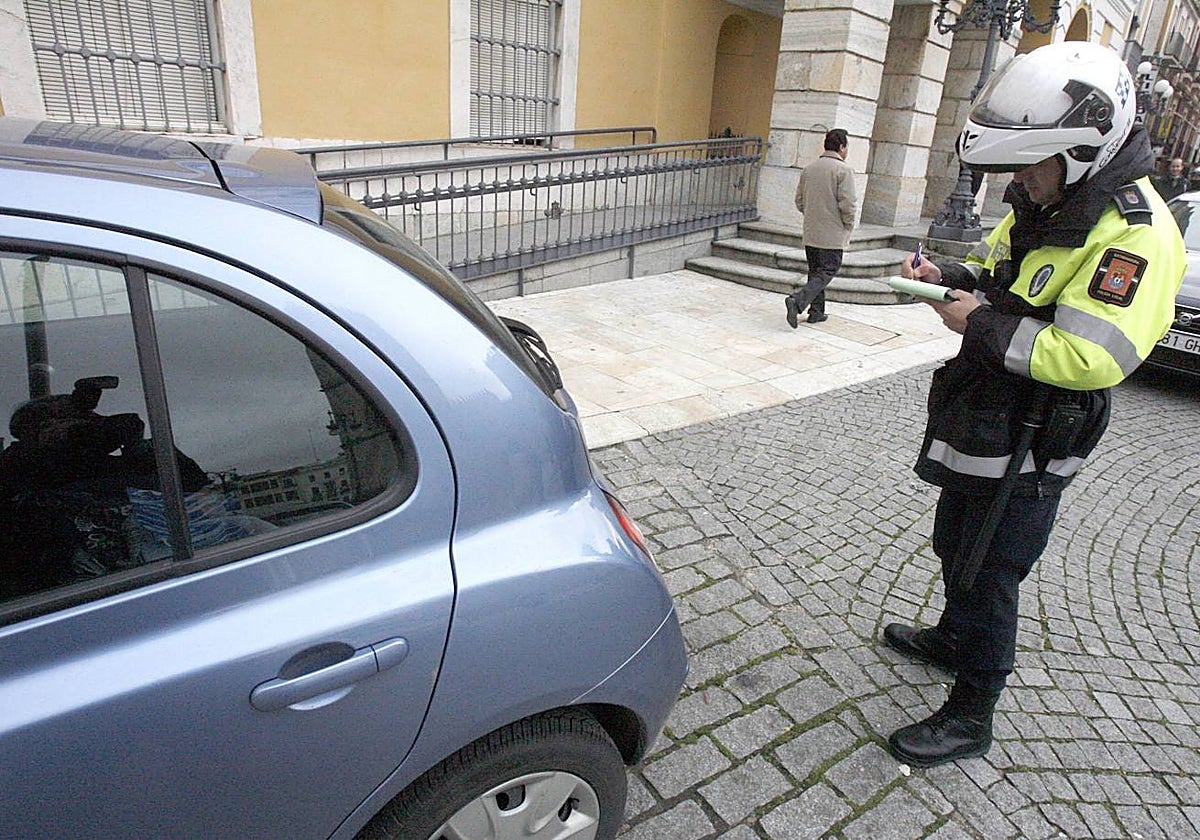 Un policía pone una multa en plaza de España.