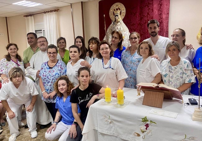 Foto de familia de los trabajadores de la residencia Nuestra Señora del Rosario junto a la patrona.