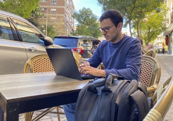 Una persona trabaja con su ordenador en una cafetería.