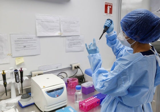 Una técnico de laboratorio con una muestra.