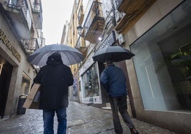 Dos personas se protegen de la lluvia en Cáceres en la última semana del pasado enero.