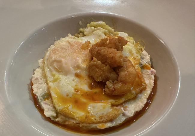 Ensaladilla con huevo frito y gambones.