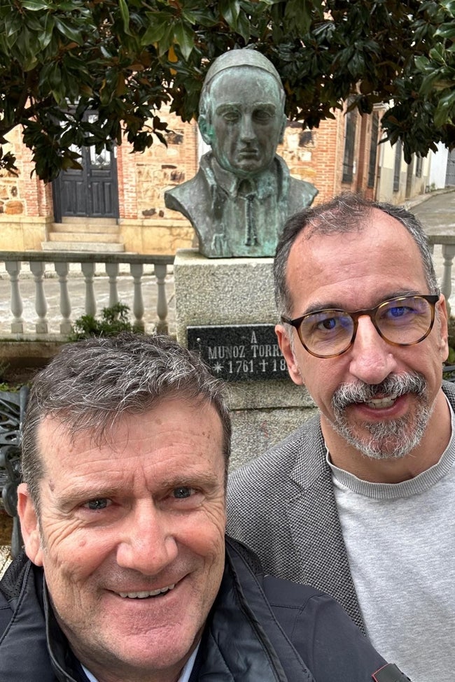 El productor ejecutivo José Luis Pastor y el guionista Fernando Rodríguez con el busto de Muñoz Torrero detrás en Cabeza del Buey.