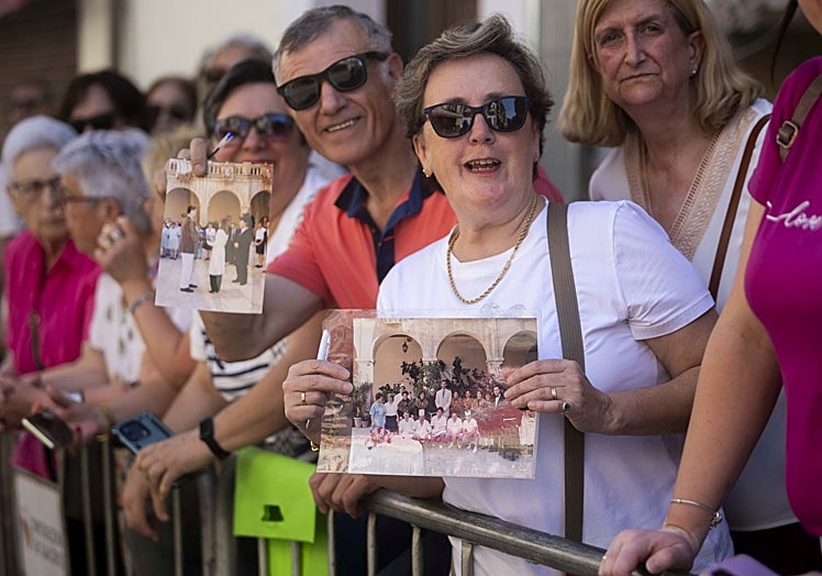 Dos vecinos de Guadalupe, este miércoles, con fotos en las que aparecen los Reyes en su anterior visita a Guadalupe en el año 2004.