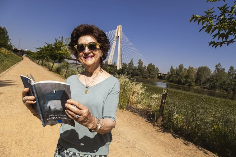 Julita de la Cruz con su nuevo poemario en castúo junto al Guadiana, al que dedica un poema.