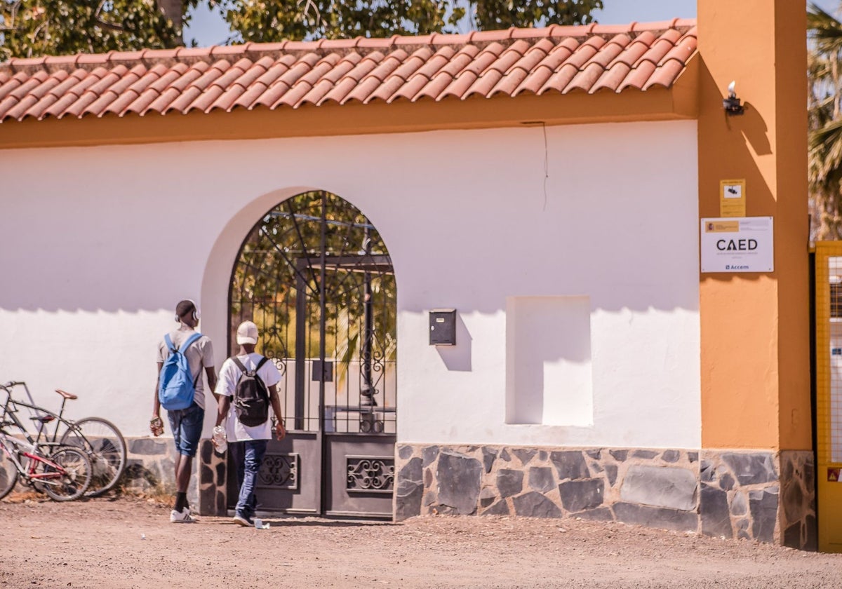 Dos personas acceden al centro de acogida de El Prado en Mérida.