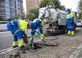 Operarios de Aqualia trabajan en la limpieza de una alcantarilla en el Paseo Fluvial.