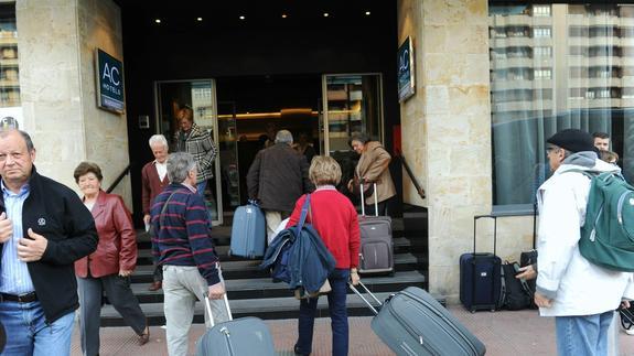 Un grupo de turistas llega a un hotel. 