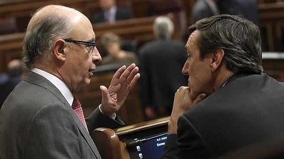 Cristóbal Montoro y Rafael Hernando conversan durante el Pleno en el Congreso. 