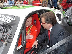El presidente de la Junta, Guillermo Fernández Vara, charla con el piloto Ángel Santos un Ferrari de competición en Mérida. / BRÍGIDO