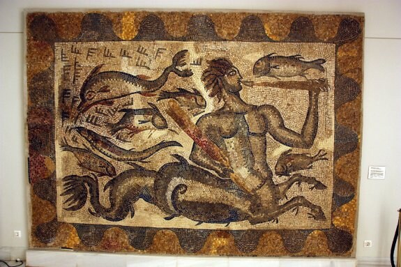  Mosaico. El mosaico en el que aparece un gran tritón rodeado de peces y un delfín decoraba uno de los baños del complejo termal. Hoy se encuentra en la Diputación de Badajoz. :: hoy