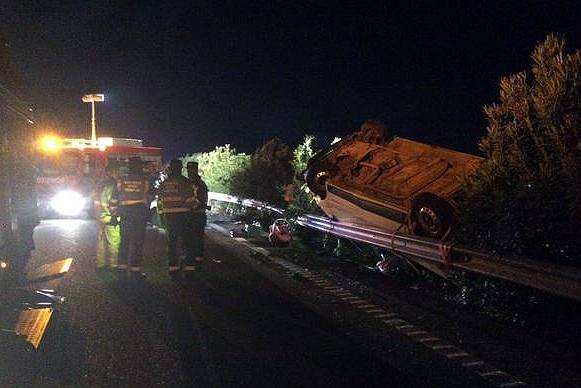 Agentes de la Guardia Civil y personal sanitario junto a la furgoneta volcada