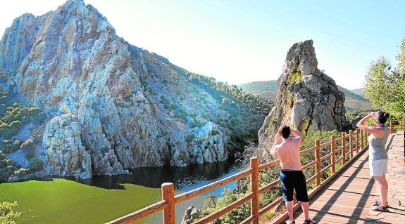 Dos turistas toman fotos en el interior del Parque Nacional de Monfragüe. :: hoy