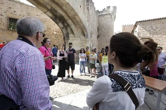 Grupo de turistas escucha las explicaciones de una guía en el Arco de la Estrella el Jueves Santo. :: l.c.
