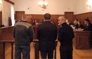 Los acusados (de espaldas) son asistidos por un intérprete, situado a la derecha. / CASIMIRO MORENO