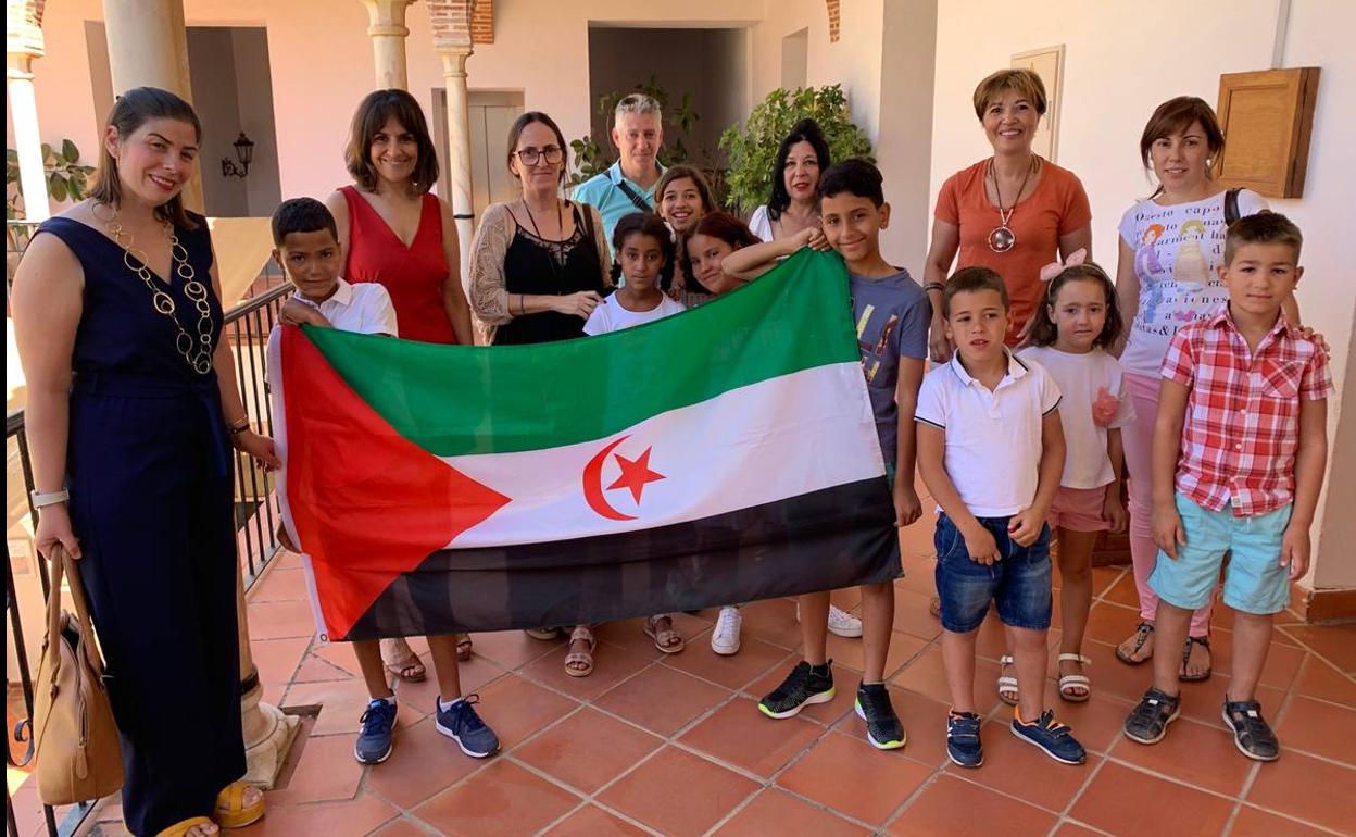 Lis niños y noiñas con sus familias de acogida y las concejalas en el Ayuntamiento 