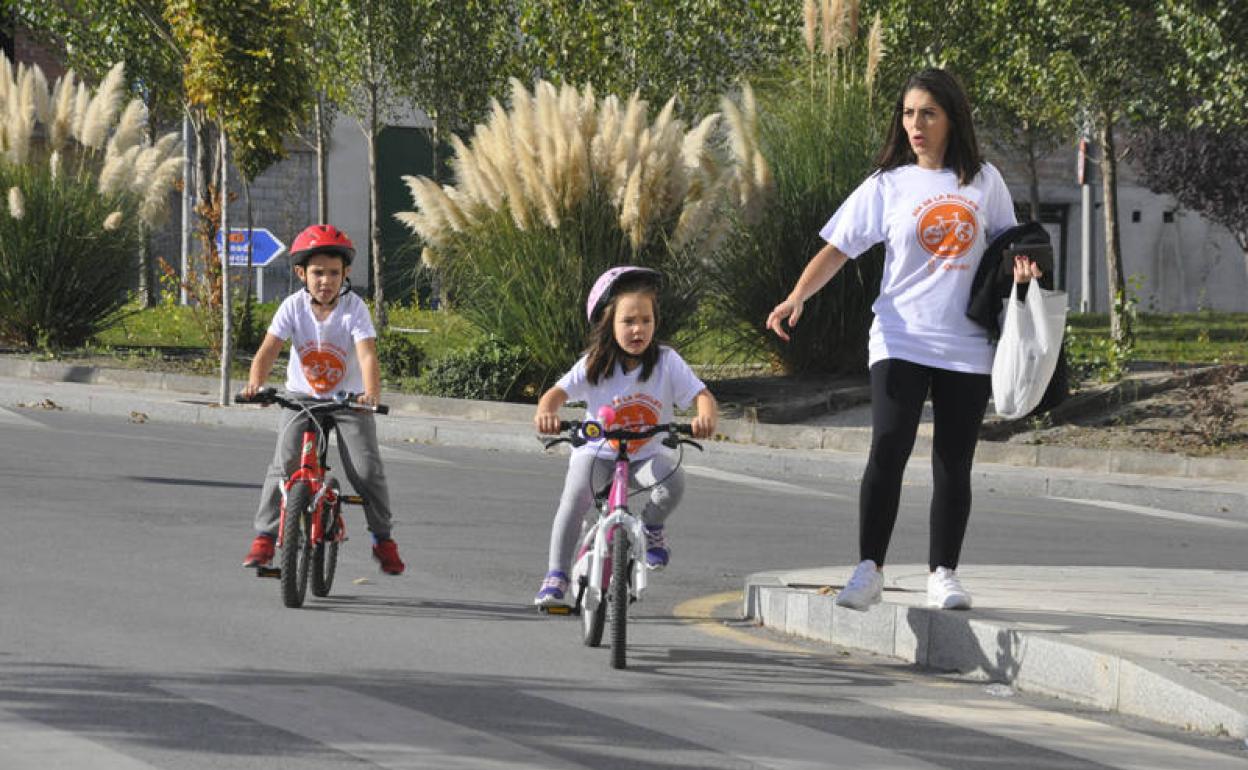 Una madre con dos niños disfrutando de un paseo en bici el Día de la Bicicleta