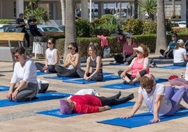 Sesión de yoga en la explanada del Faro de Roquetas.