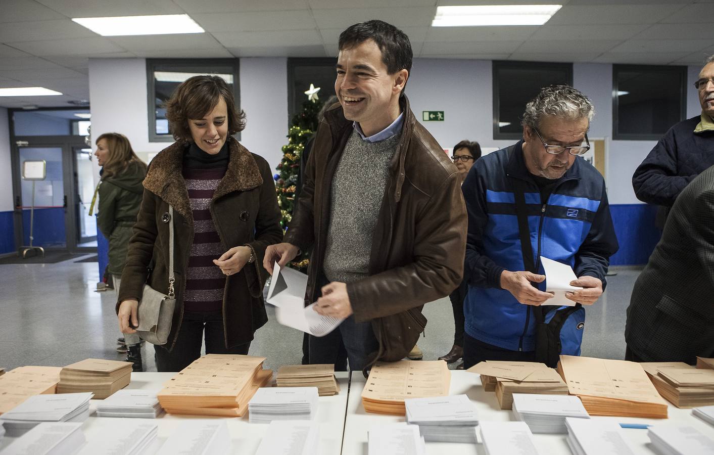 El candidato de UPYD a la presidencia del Gobierno, Andrés Herzog (c), acompañado de su mujer, Natasha Goffman, coge sus papeletas en el Centro Dotacional de Arganzuela donde ha votado esta mañana.