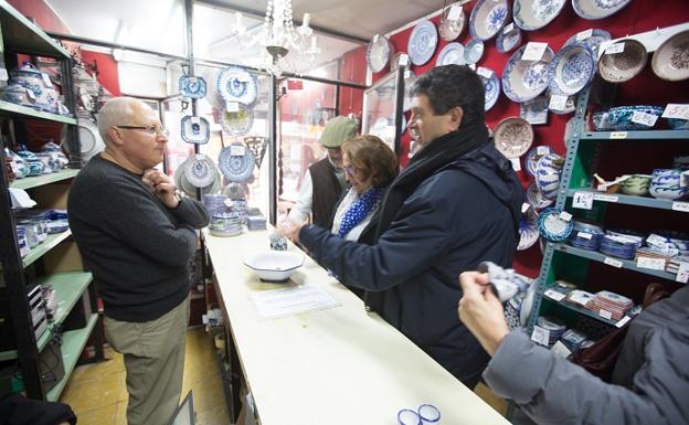 Imagen principal - Los clientes preguntan siempre a Juan Miguel, experto en cerámica de Granada, quien embala las piezas con cariño y hace las cuentas a mano.