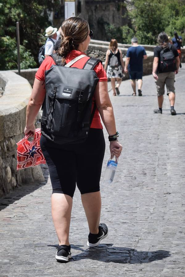 Granadinos y visitantes se las apañan en las calles para no sufrir mucho el enorme calor de estos días